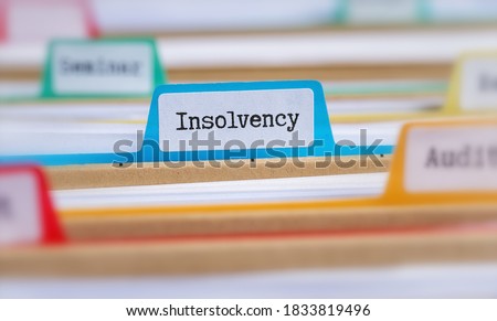 File folders with a tab labeled Insolvency Royalty-Free Stock Photo #1833819496