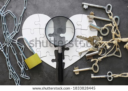 White heart-shaped puzzle. Heart affairs. Undivided love. Broken heart. The key to the heart. Closed heart on a lock. Concept love.