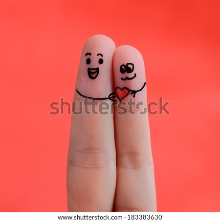 people finger couple in love with painted smiley and hugging