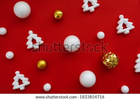 
red christmas background with white decorative christmas trees and balls