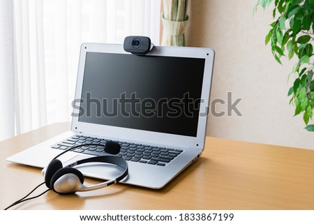 Notebook PC with webcam on table. Royalty-Free Stock Photo #1833867199