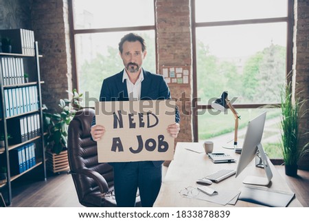 Need a job. Profile photo of moody despair laid off office worker mature guy holding placard poster looking for new job last working day workplace 
