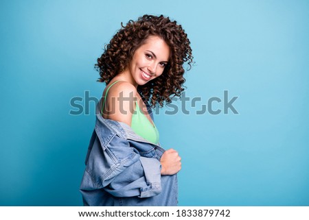 Photo of cute lovely young lady shiny smiling look camera flirty suggest nice handsome guy approach her first buy cocktail wear green crop top denim jacket isolated blue color background