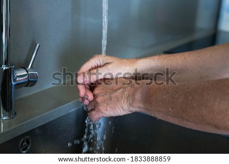 Woman washing hands to prevent covid-19