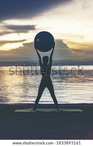 Silhouette woman practice yoga summer vacation on the the beach ,Travel in tropical beach Thailand,vacations and relaxation Concept
