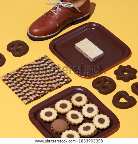 Stylish chocolate isomertric composition. Cookies and vintage retro shoes. Fashion funny sweet christmas holiday. Winter time concept art.