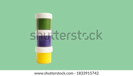 gouache three cans multicolored isolated on a green background with space for text                             