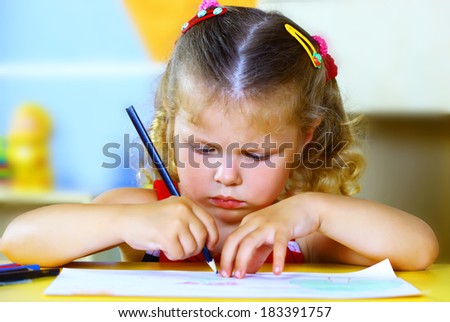 Little girl draws