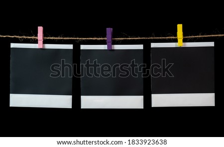 Blank square photo frames hanging on a clothesline. Royalty-Free Stock Photo #1833923638