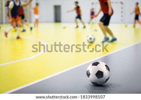 Indoor futsal soccer players playing futsal training. Indoor soccer sports hall. Futsal players kicking ball. Futsal training dribbling drill. Sports background. Indoor soccer league Royalty-Free Stock Photo #1833998107