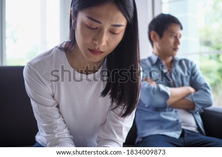 Asian women are disappointed and saddened after an argument with their husband. Asian couples are having family problems resulting in divorce. Love problem Royalty-Free Stock Photo #1834009873
