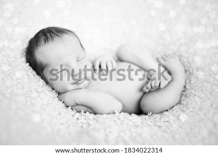 newborn baby sleeping on wool blanket. Happy baby, sleep time. Black and white picture
