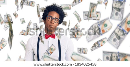 Handsome african american man with afro hair wearing hipster elegant look with serious expression on face. simple and natural looking at the camera.