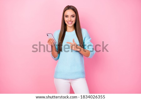 Photo of pretty manager lady hold telephone direct finger advising cool interface quality new model gadget wear knitted sweater white pants isolated pink color background