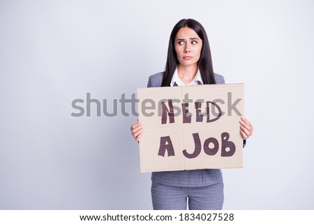 Photo frustrated upset woman banker agent coronavirus economic crisis lose work hold paper card text need job look copyspace wear checkered jacket pants isolated gray color background