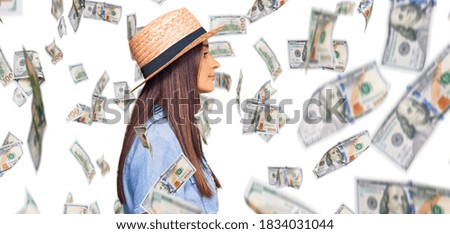 Young hispanic woman wearing summer hat looking to side, relax profile pose with natural face with confident smile.
