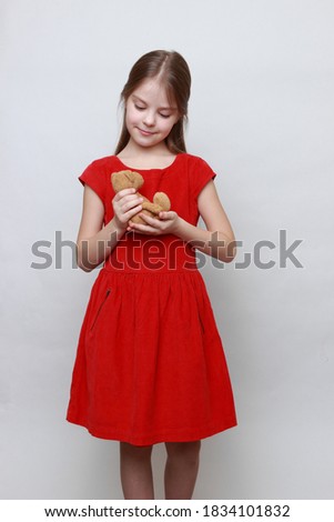 Adorable kid is holding lovely teddy bear toy.