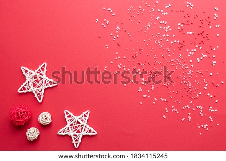 Abstract background image with decorative elements, wicker balls and stars on a red background
