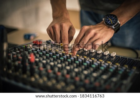 Behind the scene. Sound technician electric engineer adjusting sound elements backstage. Control audio panel. Audio mixing console
