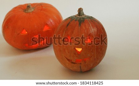 Two pumpkins with carved faces for Halloween