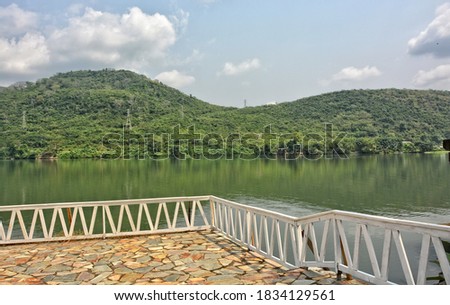 Beautiful lake, hills with lush vegetation. Tropical style. 