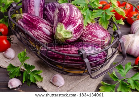 Raw vegetables in a metal basket on a dark wooden background. Selective focus.