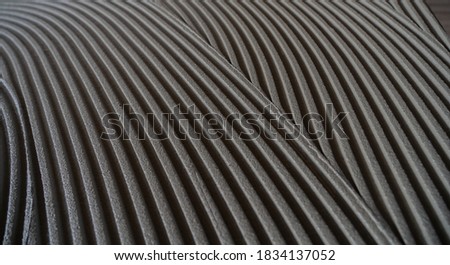 cementitious adhesive applied to the floor ready to receive the ceramic tile
 Royalty-Free Stock Photo #1834137052