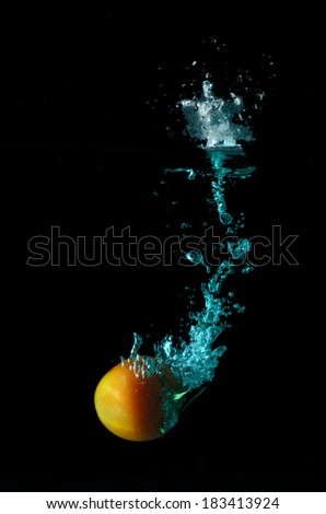 Tomato water splash on black background