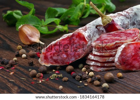 dried sausage on a wooden table. sausage fuet close-up