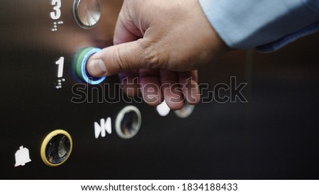 Male hand pressing the elevator button close-up