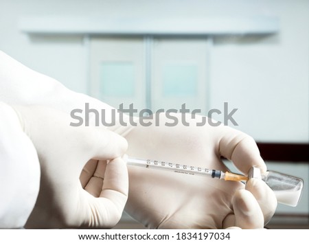 Doctor or nurse holding flu vaccine, syringe for measles injection prepares for baby and adult vaccination, medicine and drug concept, white background