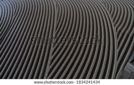 cementitious adhesive applied to the floor ready to receive the ceramic tile
 Royalty-Free Stock Photo #1834241434