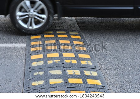 Speed bump on asphalt road when and car Royalty-Free Stock Photo #1834243543