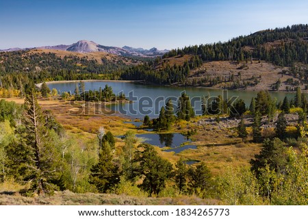 A scenic view of Red Lake and surrounding forests in the mountains of Northern California on a beautiful, sunny Autumn day.