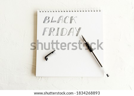 Notepad with pen and copy space, black friday seasonal holiday. Offering and promotions, bargains and clearances at shops. Isolated notebook with pencil. Brochure or template for advertisement