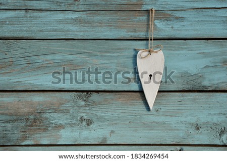 White heart on a blue old vintage wood wall isolated close up
