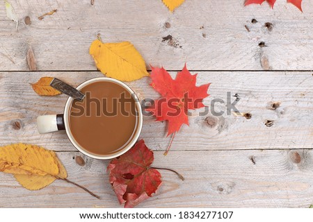 Autumn drink, seasonal composition, hot coffee with cinnamon in iron mugs on wooden background, copy space, Happy thanksgiving concept, greeting card,