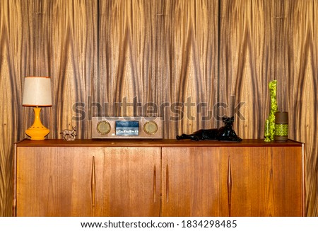 Retro 1970s cabinet with old radio, tiger statue, lamp and vases  Royalty-Free Stock Photo #1834298485