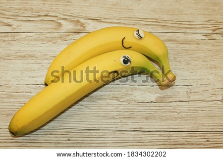 male and female bananas cuddeling one is happy one is sad