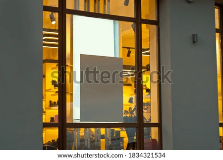 Banner for advertising in a shop window. Sign Board behind the glass. Copy space and space for text. Mockup for design. Blank template for advertising.