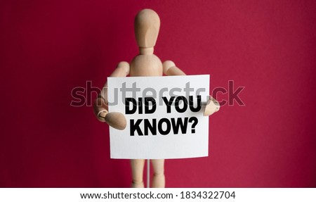 The wooden man holds a white sign with the text DID YOU KNOW in his hands. The content of the lettering has implications for business concept and marketing.