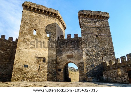 Main entrance to medieval Genoese fortress in Sudak, Crimea. It's protected by 2 powerful watch towers, guarded city from land attacks in XIV century Royalty-Free Stock Photo #1834327315