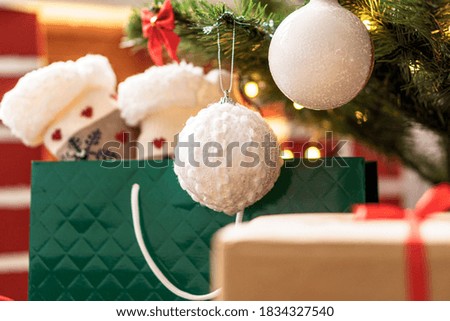 Xmas, winter, new year, Celebration, family, gift concept - Holiday atmosphere at home. Bright presents boxes under Christmas tree decorated with balls on background red fireplace with burning fire