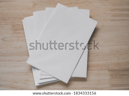 Top view of blank business cards isolated on wood background. Poster mock-ups paper, white paper Blank portrait A4. brochure magazine isolated, use banners products business cards to showcase your