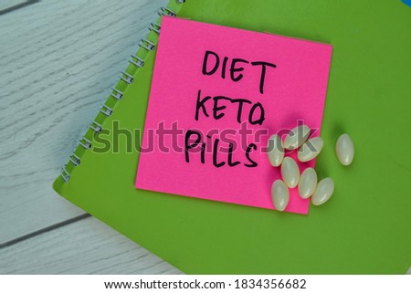 Diet Keto Pills write on sticky notes isolated on office desk. Selective focus on Diet Keto Pills