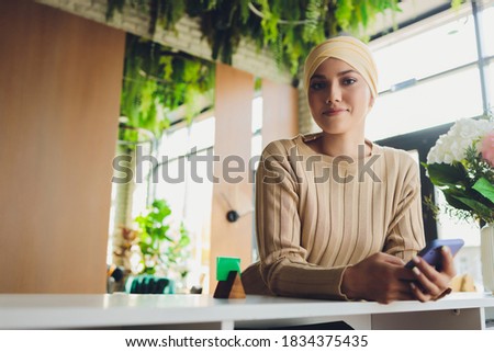Portrait of a beautiful, elegant and attractive young Malay Asian Muslim woman in a dress and an hijab head scarf. Royalty-Free Stock Photo #1834375435