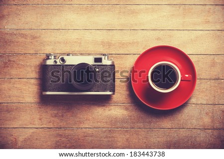 Retro camera and cup of a coffee.