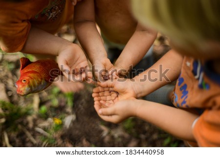 little boys holding worms on ther hands  Royalty-Free Stock Photo #1834440958