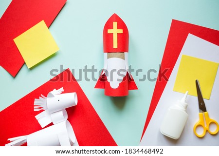 paper craft for kids. DIY toy Saint Nicholas and white horse for sinterklaas day. create art for children. Netherlands Santa Claus Royalty-Free Stock Photo #1834468492