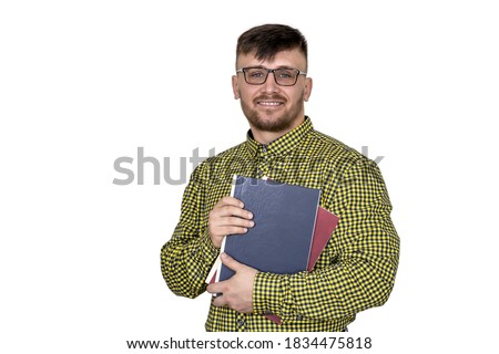 A man in a plaid shirt with books in his hands.